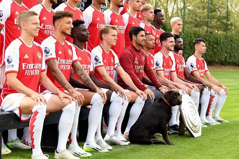 Arsenal Manager Mikel Arteta, Bukayo Saka, Martin Odegaard and Gabriel Jesus with the Arsenal Therapy Dog Win during the Arsenal Men's team group shoot at London Colney on September 18, 2023